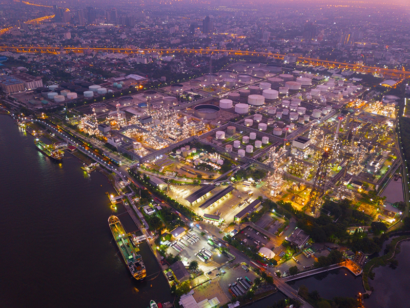 Aerial view of Petroleum's oil refinery in industrial engineering concept. Oil and gas tanks industry at sunset. Modern factory