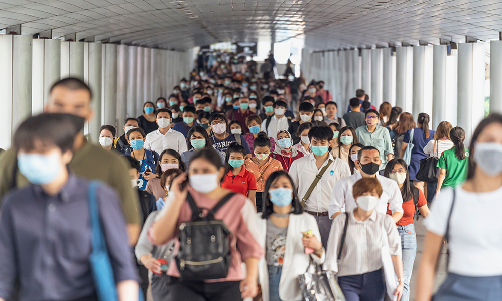 BANGKOK, THAILAND - MAR 2020 : Crowd of unrecognizable business people wearing surgical mask for prevent coronavirus Outbreak in rush hour working day on March 18, 2020 at Bangkok transportation